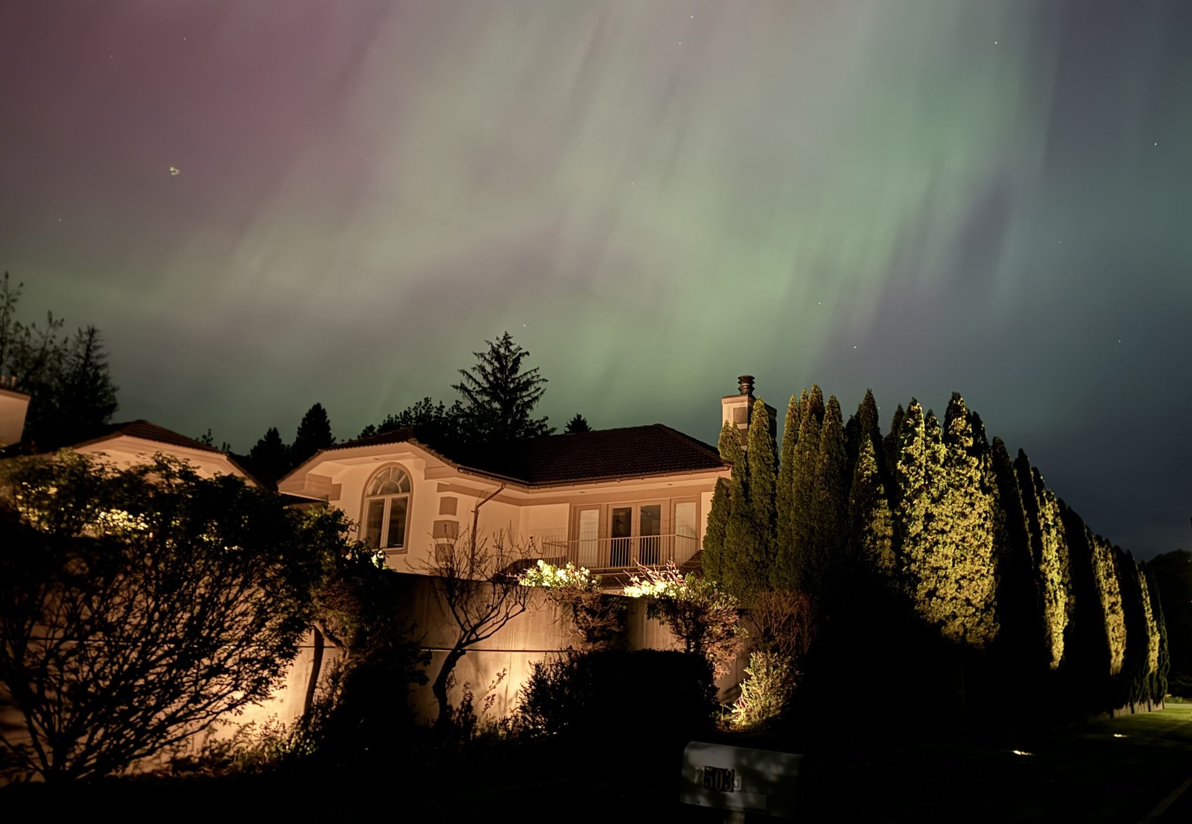 Professional landscape lighting illuminating a beautiful Sandpoint Idaho home at night